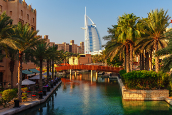 Cityscape with beautiful park with palm trees in Dubai, UAE